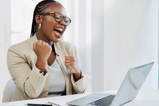 Excited woman celebrating her Regional Finance fair-credit loan approval at her laptop